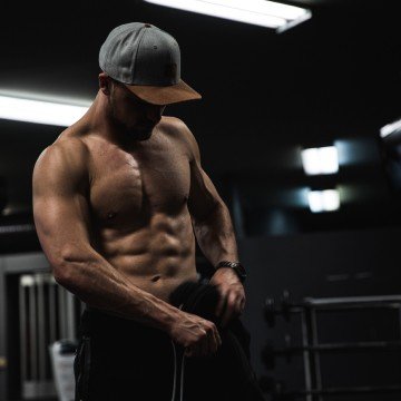 Personal training session in a modern London gym, with the trainer offering expert guidance on form and technique